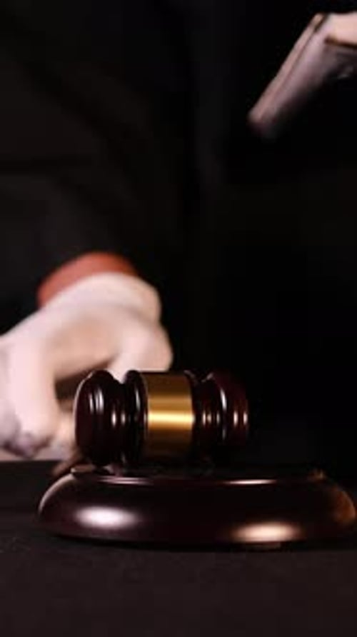 Judge Preparing to Make an Important Ruling with Gavel and Legal Books in Courtroom Setting Vertical