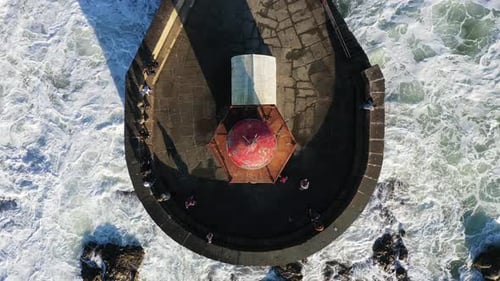 Aerial View of Lighthouse in the Midst of Dramatic Waves