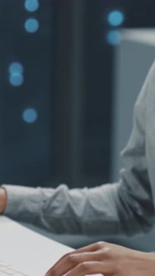 Focused Woman Typing on Keyboard in Modern Workplace