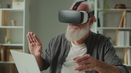 Senior Man Using VR Headset Indoors