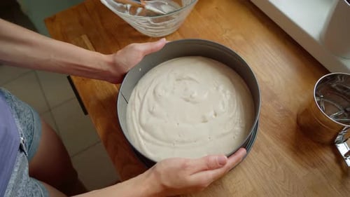 Woman Holding Baking Pan Filled with Smooth Cake Batter Preparing for Oven Baking Female Placing