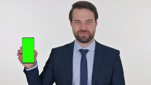 Middle Aged Businessman Holding Phone with Green Screen on white Background