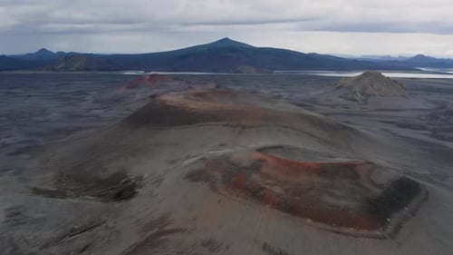 Aerial panoramic shot of volcano crater landscape and mountains during cloudscape at sky -