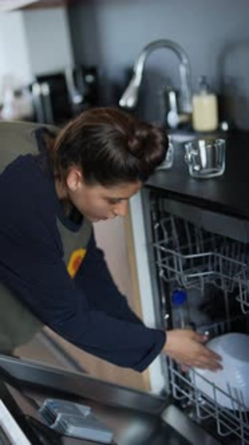Woman Doing Household Chores in Kitchen Loading Dishwasher and Cleaning Dishes