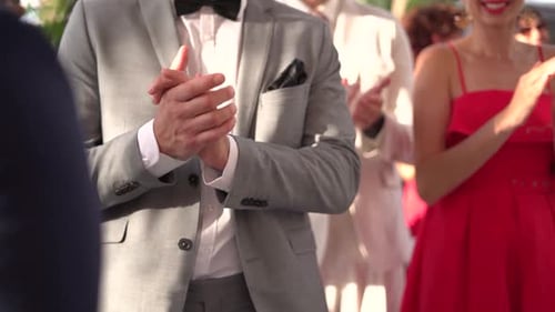 People clapping in celebration of wedding in slow motion