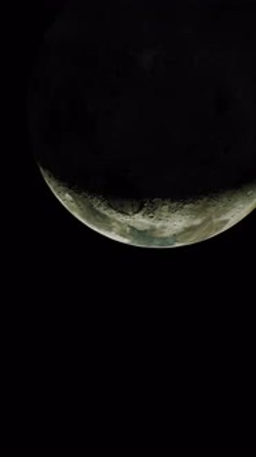 The Partially Lit Lunar Surface Visible From Space Vertical
