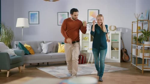 Couple Dancing and Smiling in Living Room