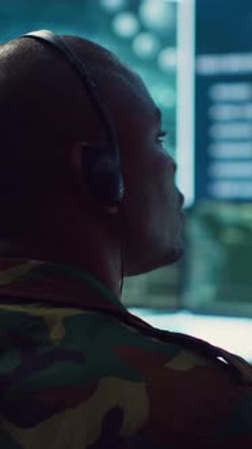 Adult Working in Dark Control Room with Headset