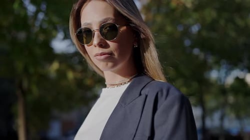 Stylish Young Woman in Sunglasses Enjoying Sunny City Day
