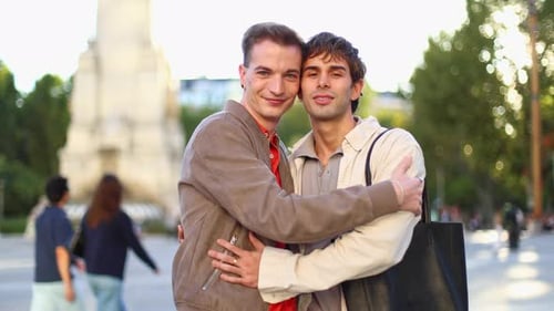 Happy Gay Couple Hugging in a City Square