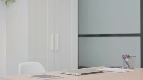 Young Businessman Coming to Office and Working on Laptop