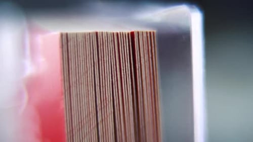 shot of a pile of visit cards in stock, red card, super slow motion, Full HD, tilt down smooth movem