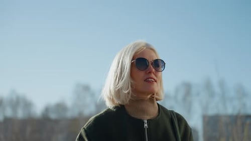 Woman with Blonde Bob Haircut Walking in City