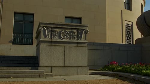 An entrance of the Federal Trade Commission panning to the Man Controlling Trade statue in spring in