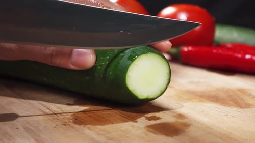 Slicing Cucumber on Cutting Board for Healthy Meal