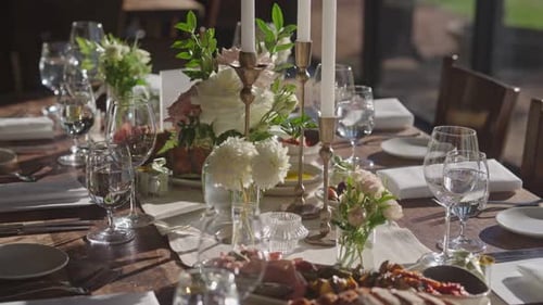 Rustic Wedding Table Close-Up with Lit Candles, Tableware, and Appetizer Serving