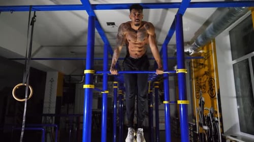 Strong African Sportsman Doing Exercises on Horizontal Bar at Modern Gym Muscular Afro American Man
