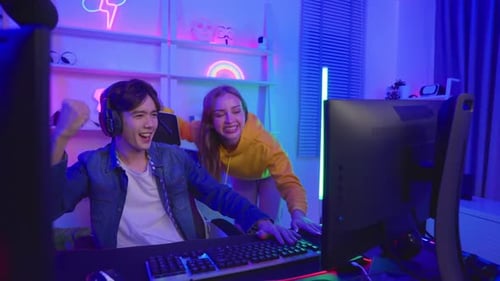 Excited Young Gamers Win Playing Video Game Together