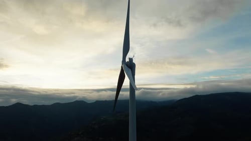 Wind Turbine at Cloudy Sunset