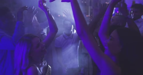 Lively Party with Dancing Young Adults at Night