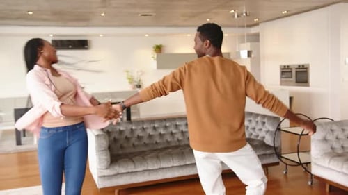 Happy Couple Dancing Together in Modern Apartment