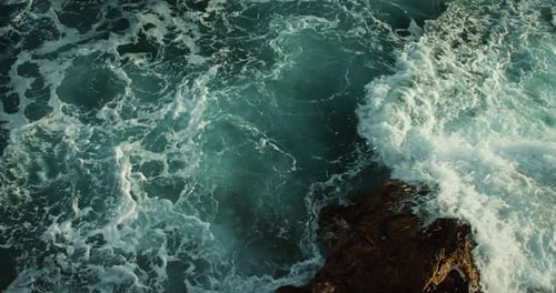 Seething Blue Ocean Waves with Sunlight Through Water Surface Natural Rocky Sea Shore Closeup