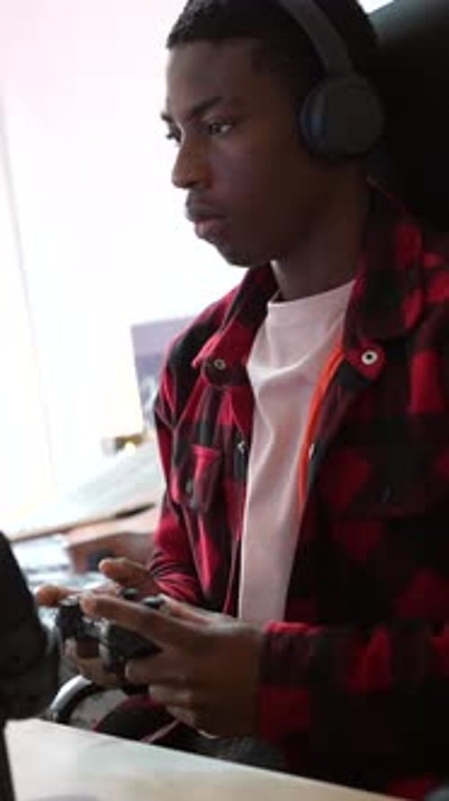 Young Adult Playing Video Game at Home