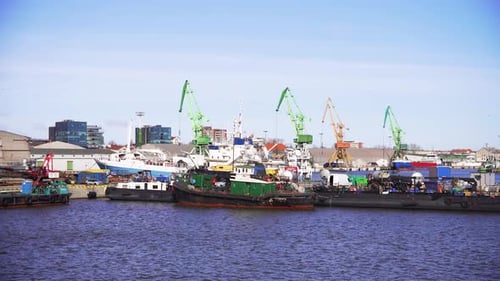 the shot of the industrial port with a lot of cranes and cargo ships in Klaipeda, Lithuania
