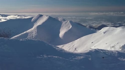 Aerial view of Snowy Mountain Ridge in Winter Alps