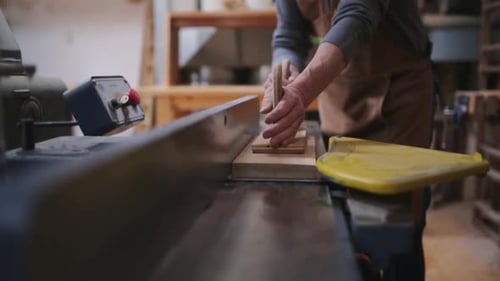 Senior carpenter skillfully operating table saw in calgary alberta workshop