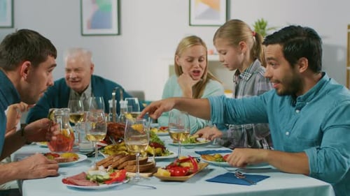 Family and Friends Gather at Dinner Table