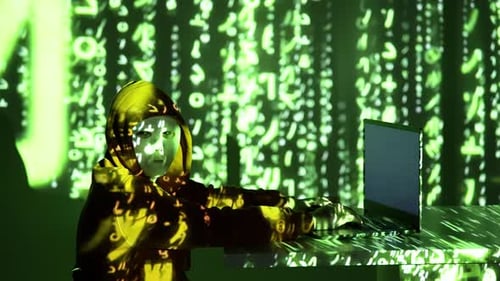 Anonymous Hacker in Hoodie and Mask Typing on Laptop under Red Blue Flashing Police Lights with Digi