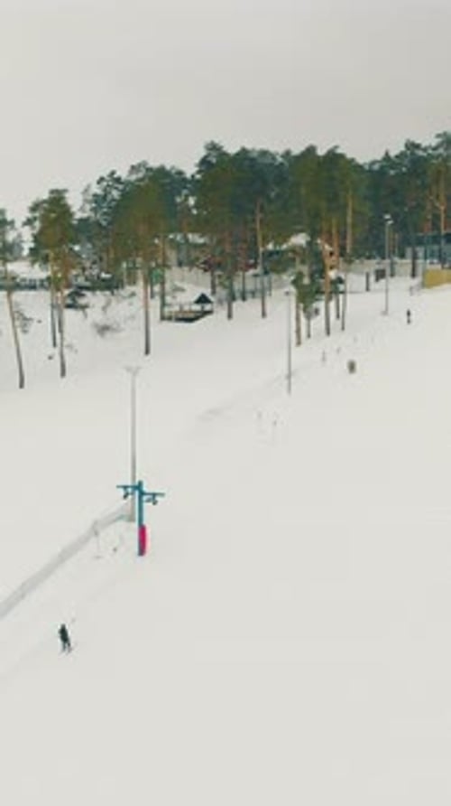Ski Resort with People and Buildings on Mountain Aerial View