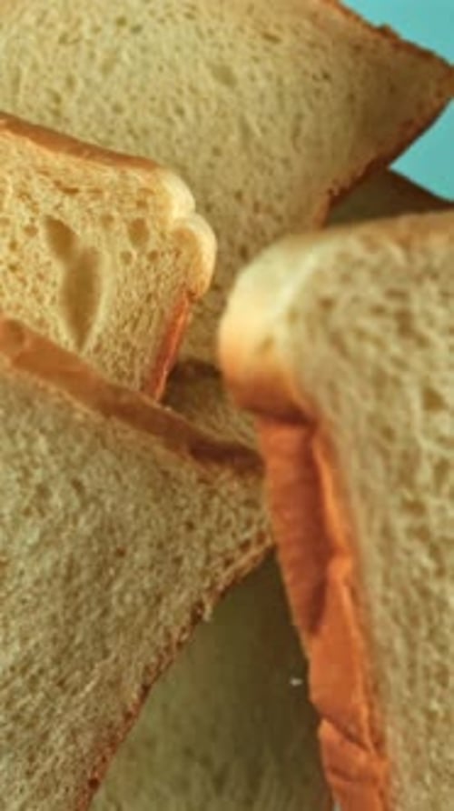 Pieces of Bread Fly Up and Fall on a Blue Background Filmed on a Highspeed Camera at 1000 Fps