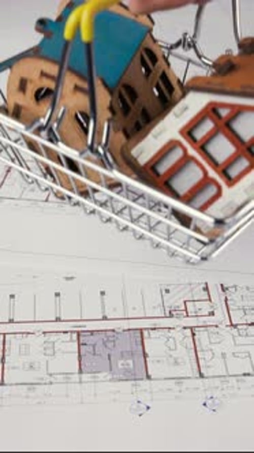 Toy Houses in Cart on Architectural Plans