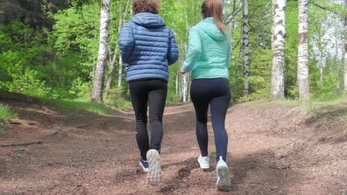 Sportive young people running. Couple run in the park during the day