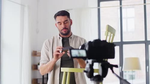 Man Recording Tutorial on Modern Tech Device Indoors