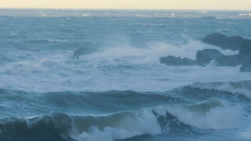 Rough Strong Ocean Waves Rolling onto Beach During Storm Darragh Crashing on Rocks in Slow Motion
