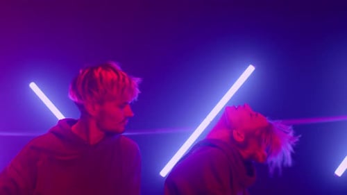 Trendy Couple Performing Hiphop Dance in Night Club Ultraviolet Backlit Close Up