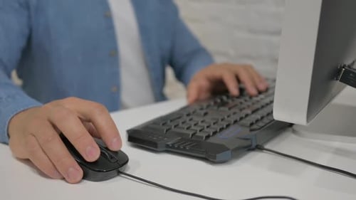 Close up of Man Using Mouse to Work on Computer