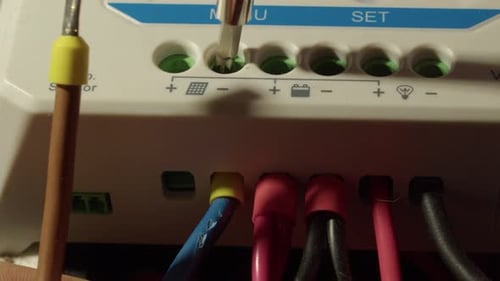 Wires from solar panels are attached to solar power controller unit