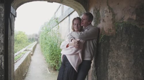 Romantic Couple Embracing in a Castle Archway