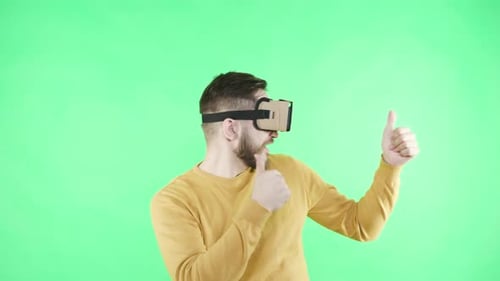 Man with VR Headset Gesturing on Green Screen