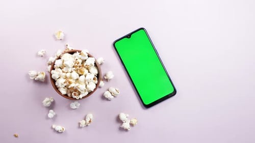Top View of Smart Phone and Popcorn on Table