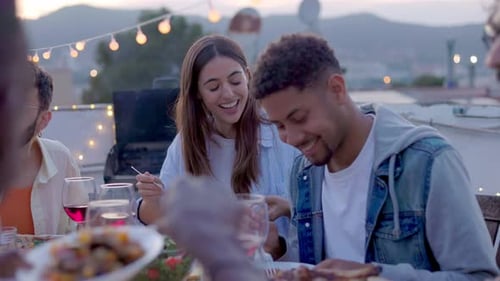 Young Group of Friends Enjoying Evening Dinner Party at Home Terrace