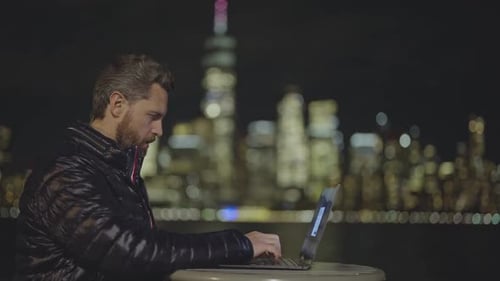 Businessman in Winter Jacket Using Laptop in City at Night Mature Businessman Overtime Work Outdoor
