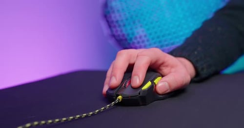 Hand using Illuminated Gaming Mouse on Pad