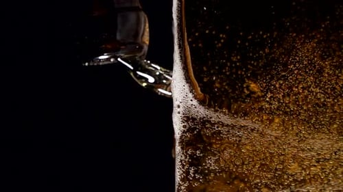 Super Slow Motion Shot of Beer Bubbles in Glass at Black Background at 1000Fps