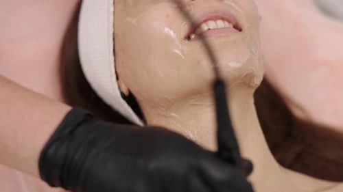 Woman Receiving a Professional Facial at Spa