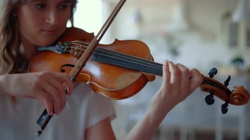 Woman Playing Violin in Home Setting